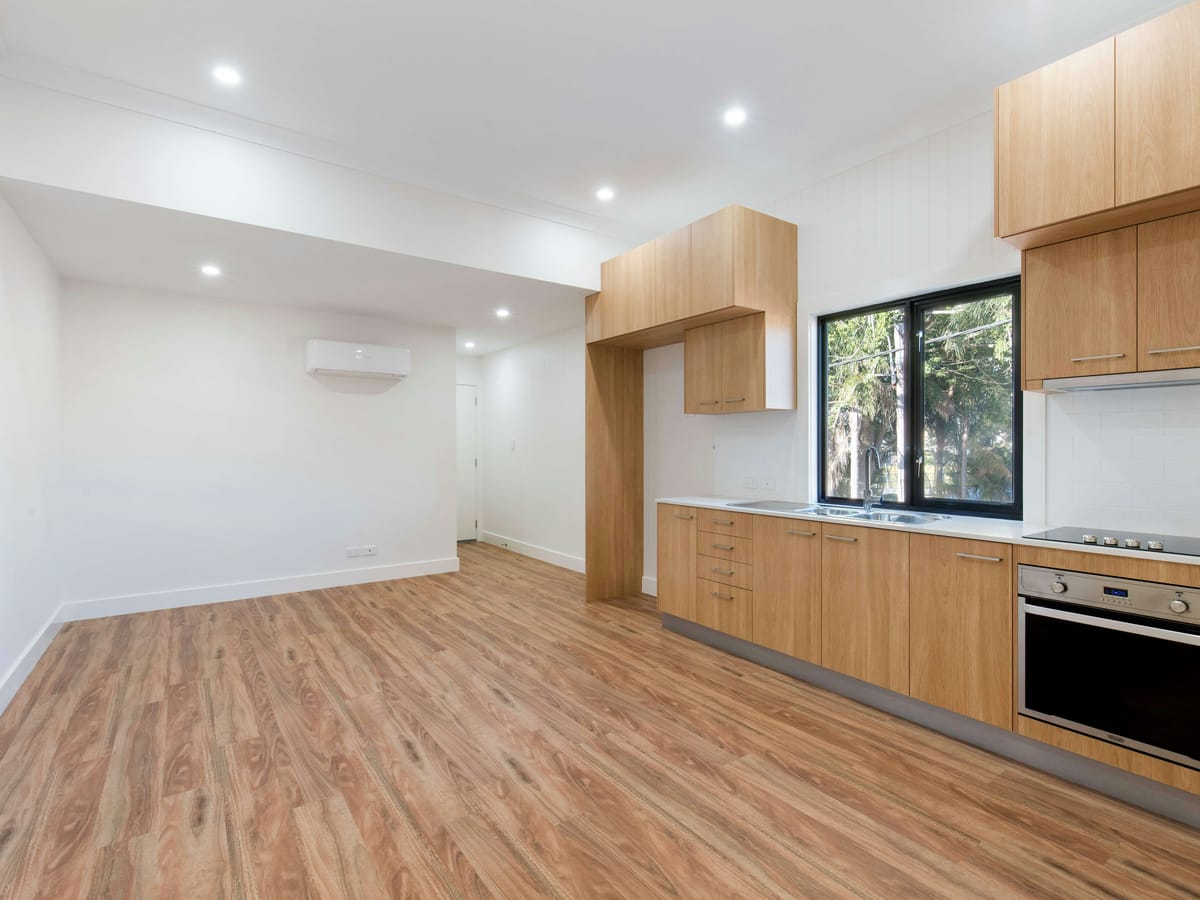 Open-plan living space with new hardwood flooring