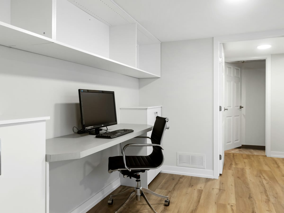 Finished basement home office with a built-in desk