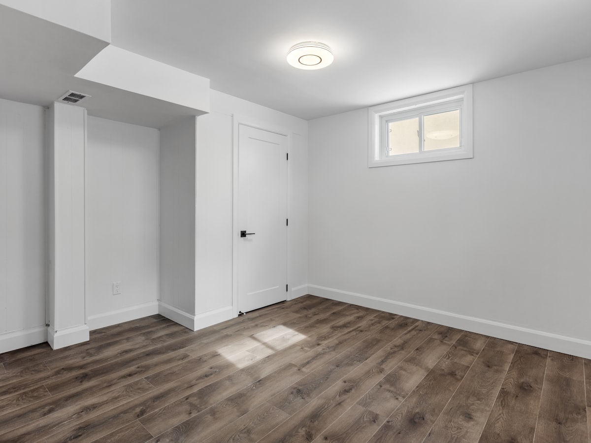 Finished basement room with new wood flooring